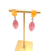 tangerine and pink drop earring on a stand