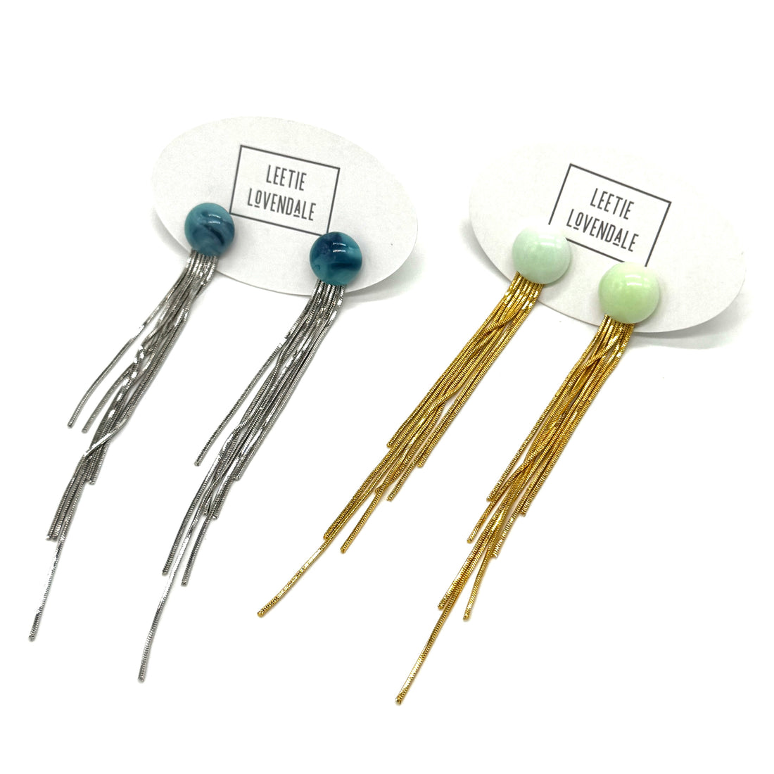 Set of fringe earrings with colorful beads on white background