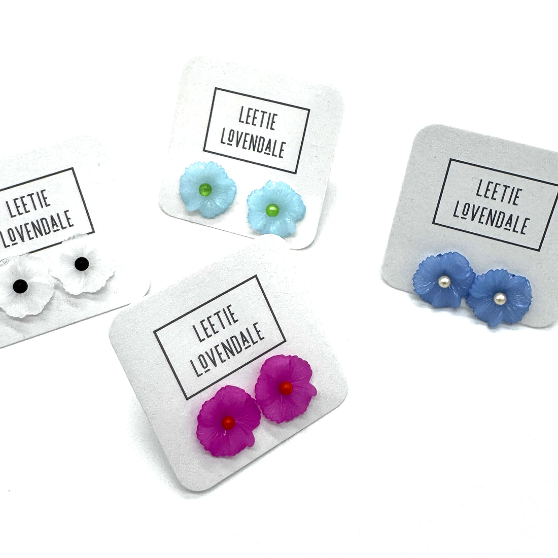 Floral earrings on display with &