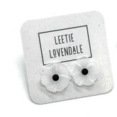 Flower-shaped earrings on a branded card with &
