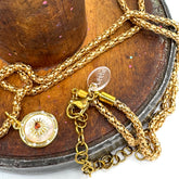 Gold necklace with a pendant on a wooden surface