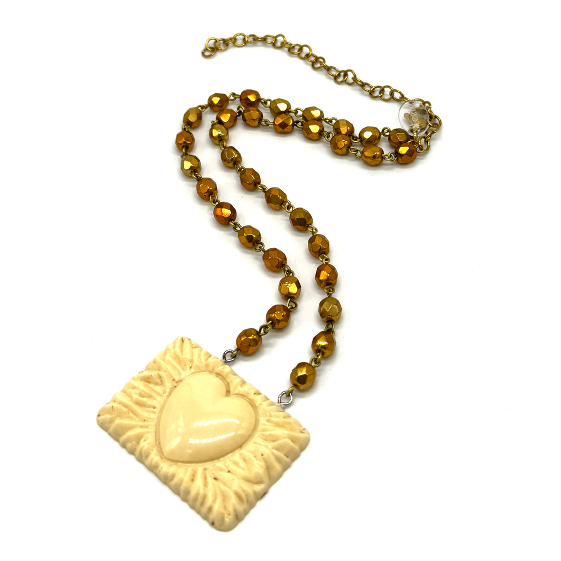 Necklace with a square pendant featuring a heart design on a white background