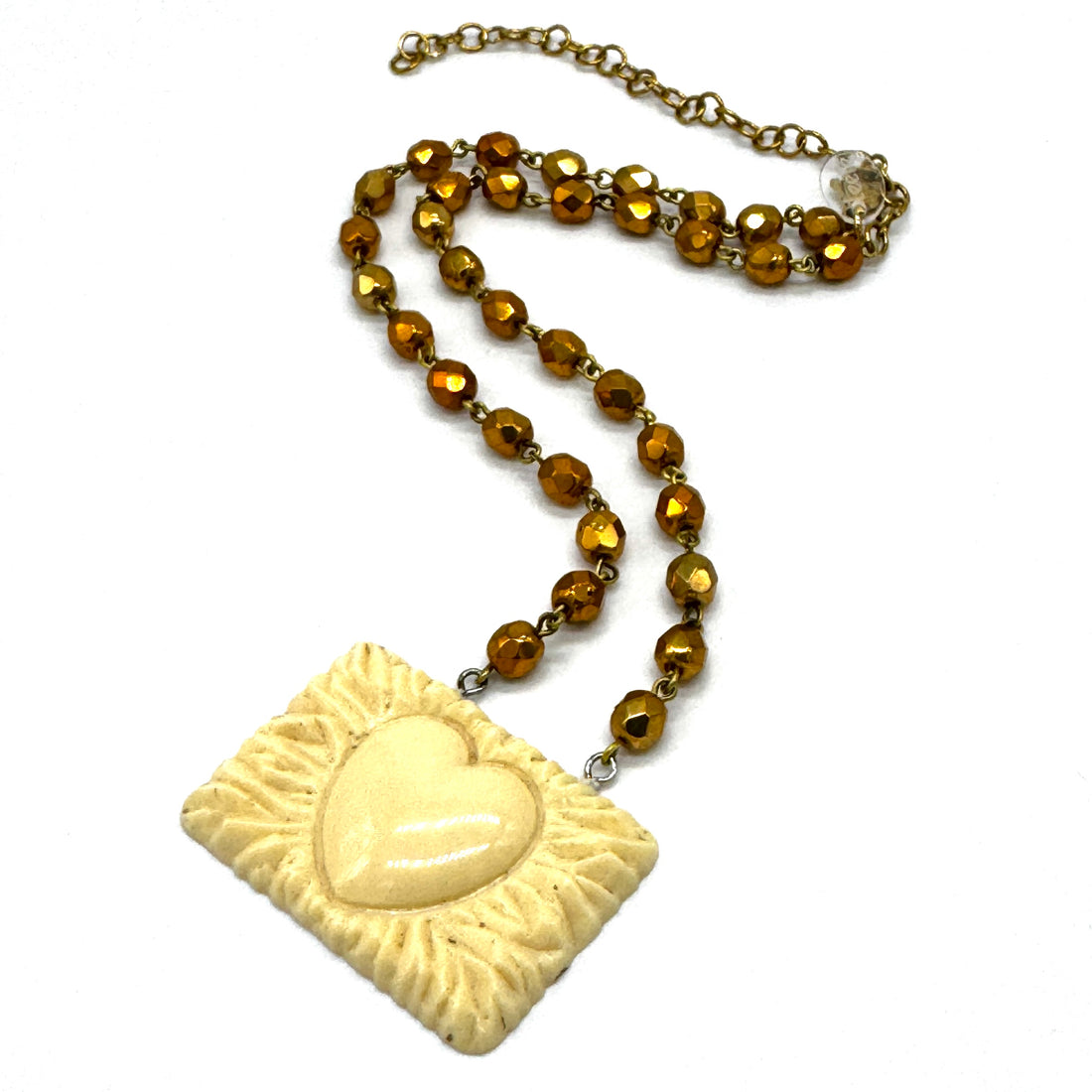 Necklace with a square pendant featuring a heart design on a white background