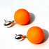 Orange spherical earrings with silver posts on a white background