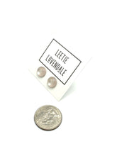 small moonglow stud earrings with quarter in picture to show size