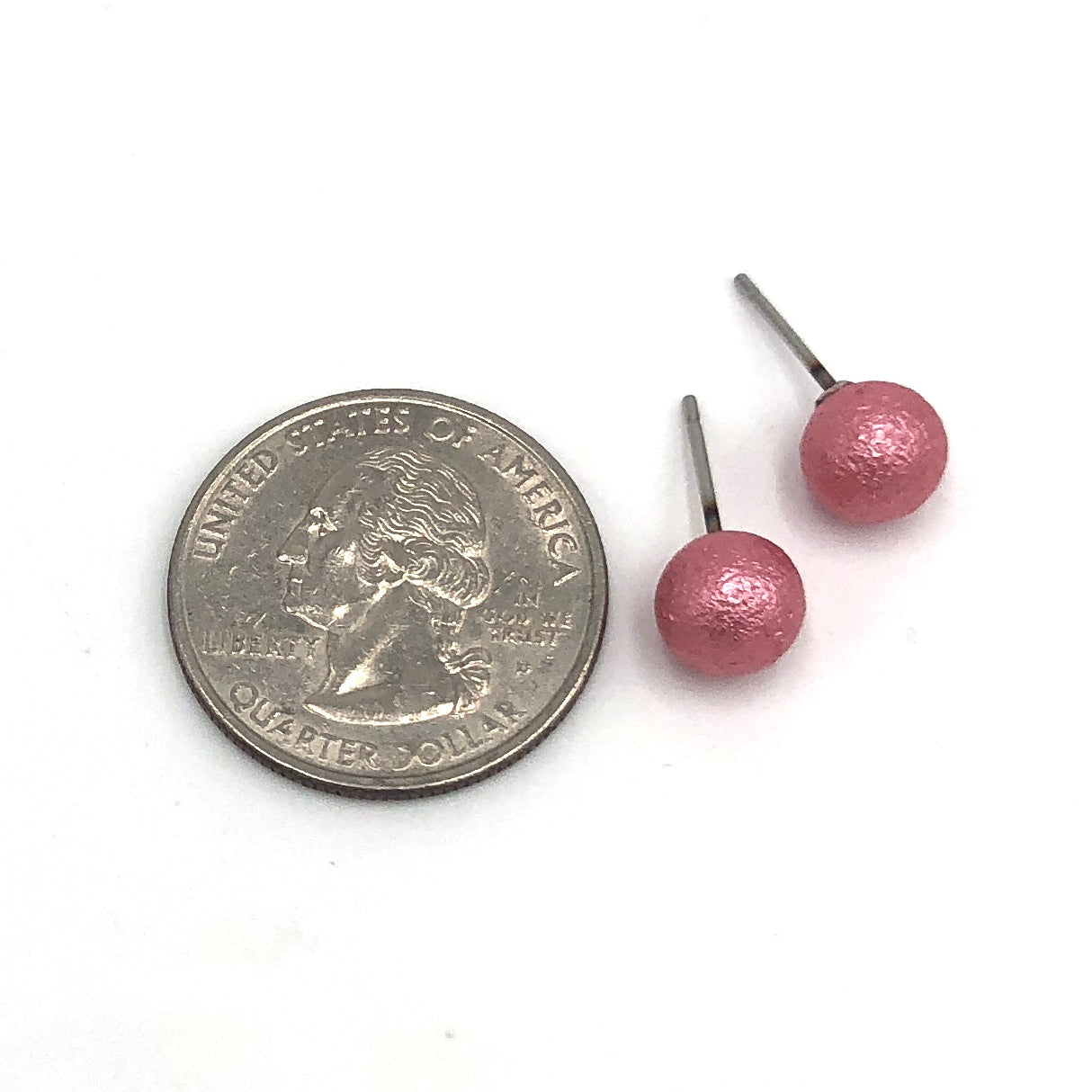 pitted ball stud earrings with quarter in picture to show size