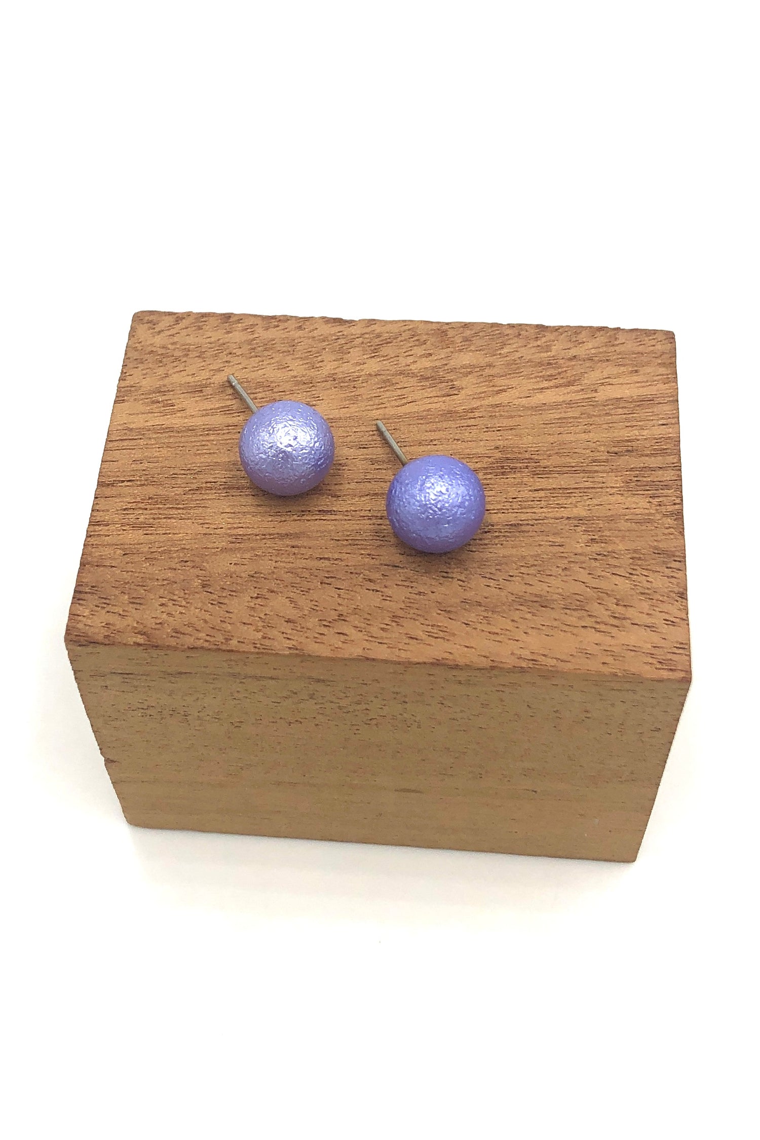 periwinkle pitted ball stud earrings on wood stand