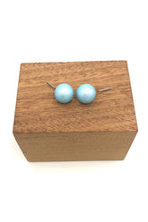 aqua pitted ball stud earrings on stand