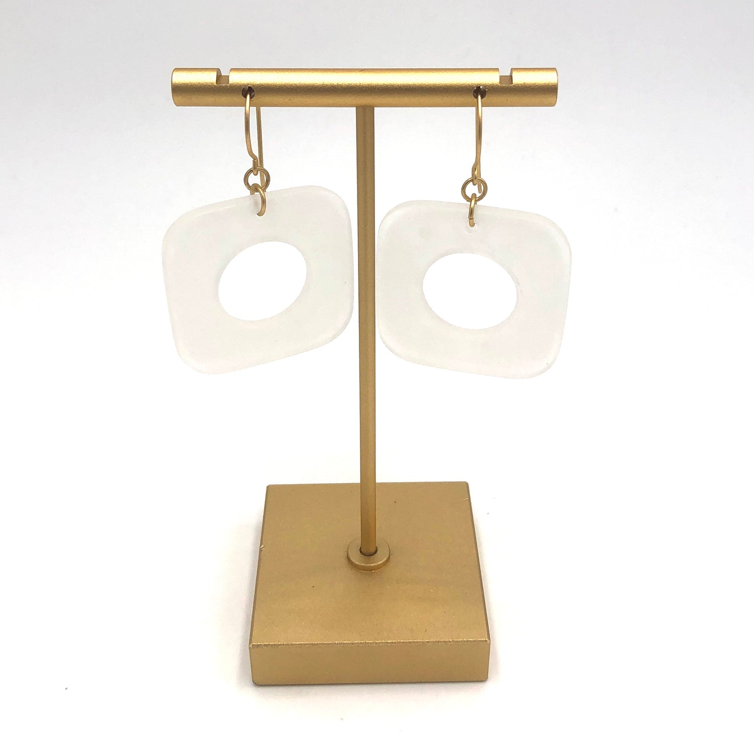 clear frosted square dangle earrings on a stand