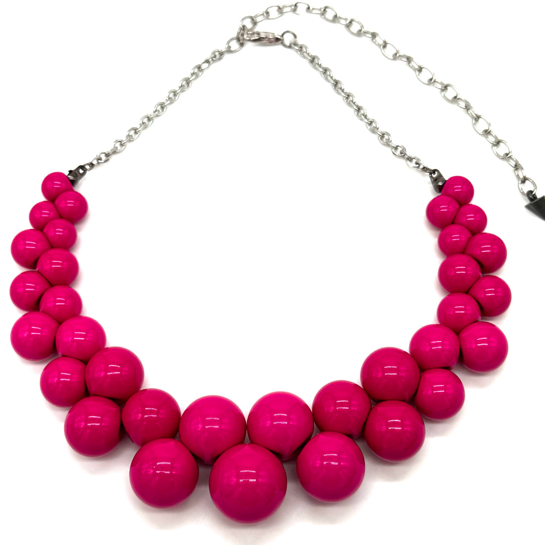 Necklace with bright pink beads on a white background
