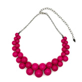 Necklace with pink beads and a silver chain on a white background