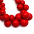 Close-up of red beads on a white background
