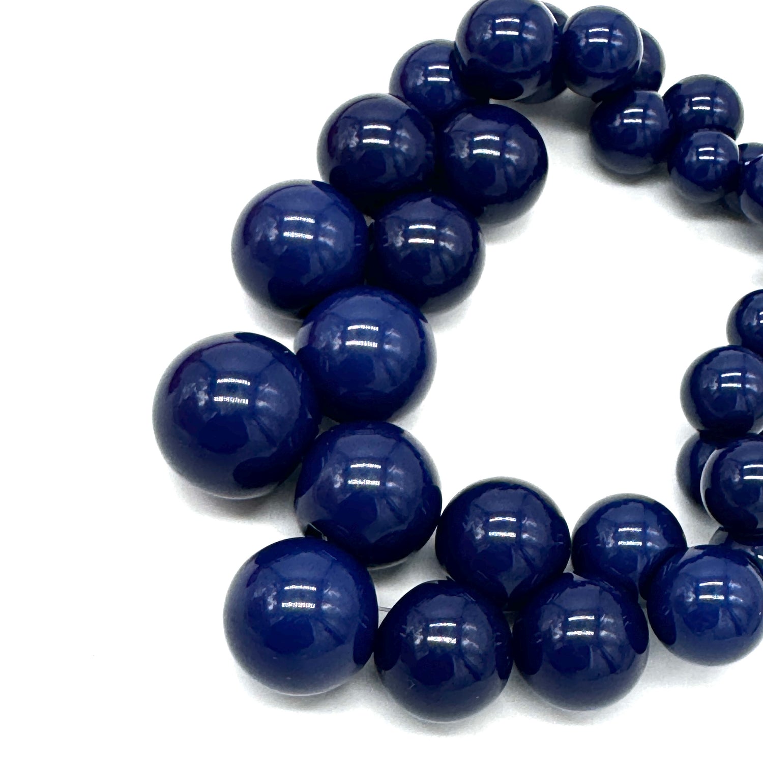 Close-up of a blue beaded necklace on a white background