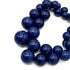 Close-up of a blue beaded necklace on a white background