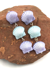 seashell style earrings on rock
