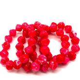 String of red beads on a white background