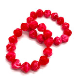 Red beaded bracelet on a white background