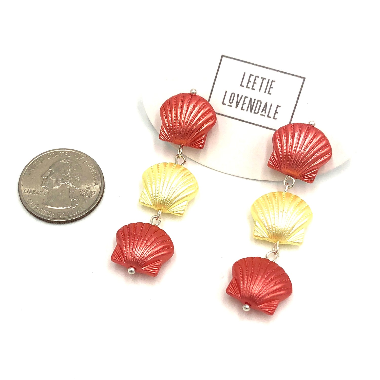 quarter in picture next to seashell style earrings to show size