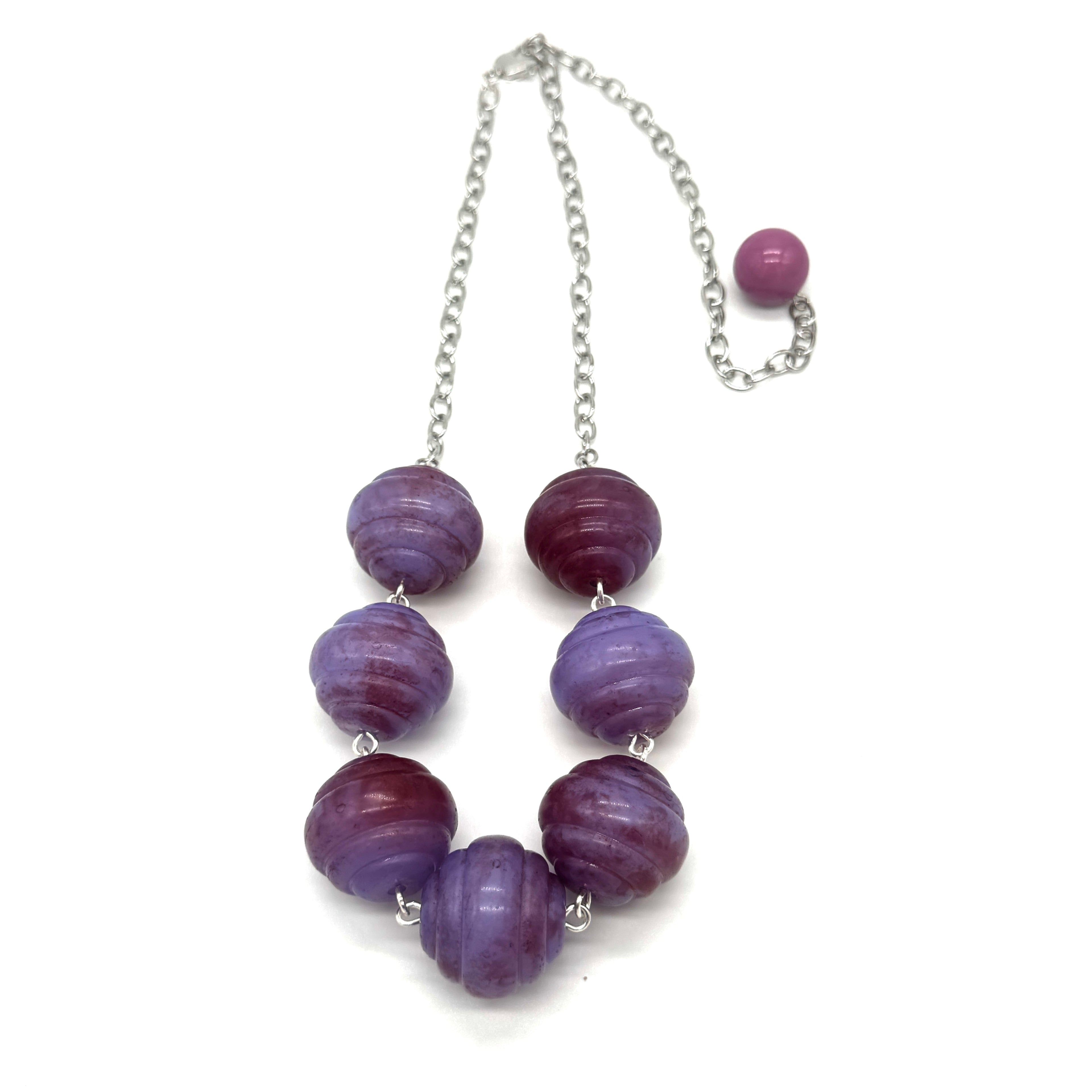 Necklace with purple beads on a white background