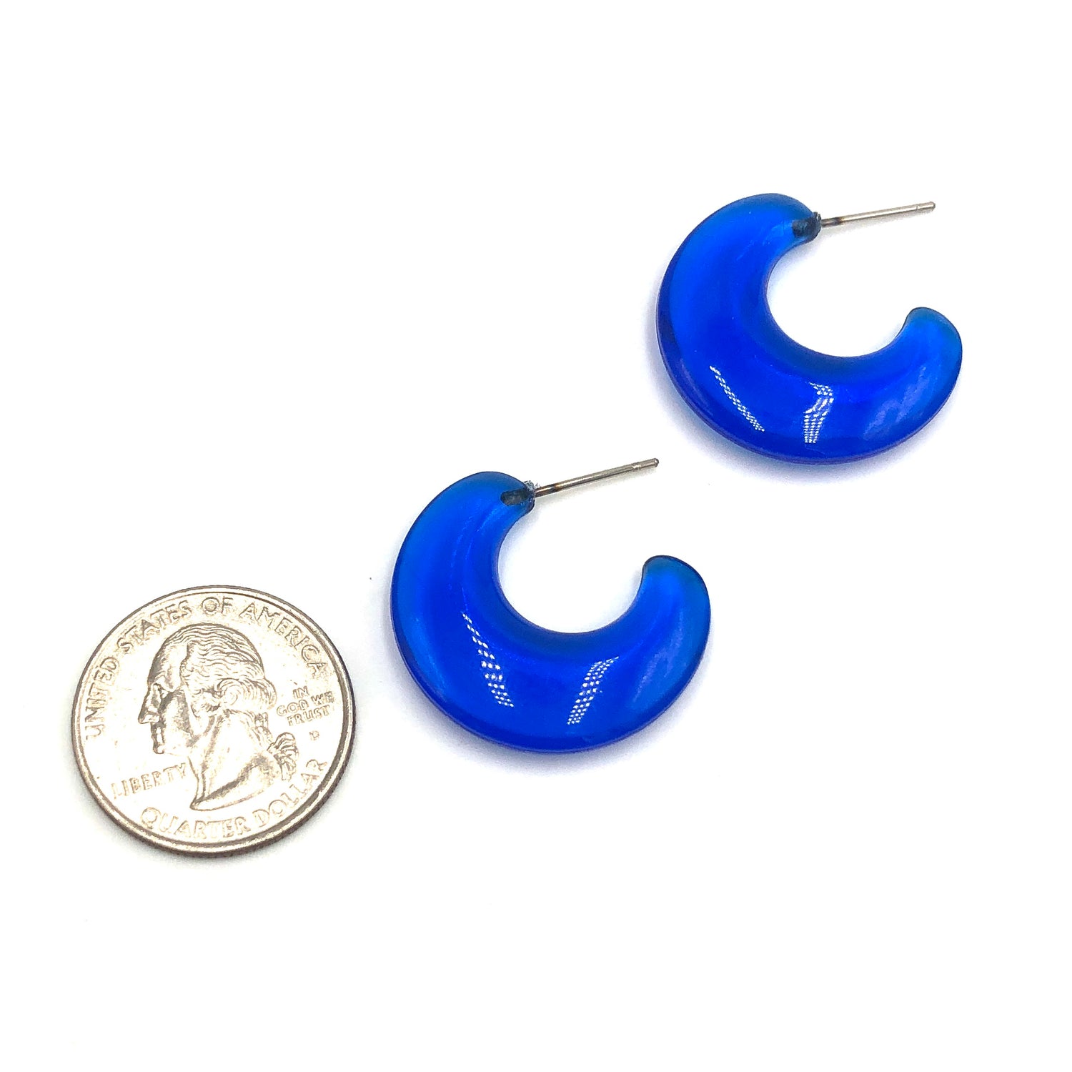 quarter in picture next to capri blue flat hoop earrings to show size