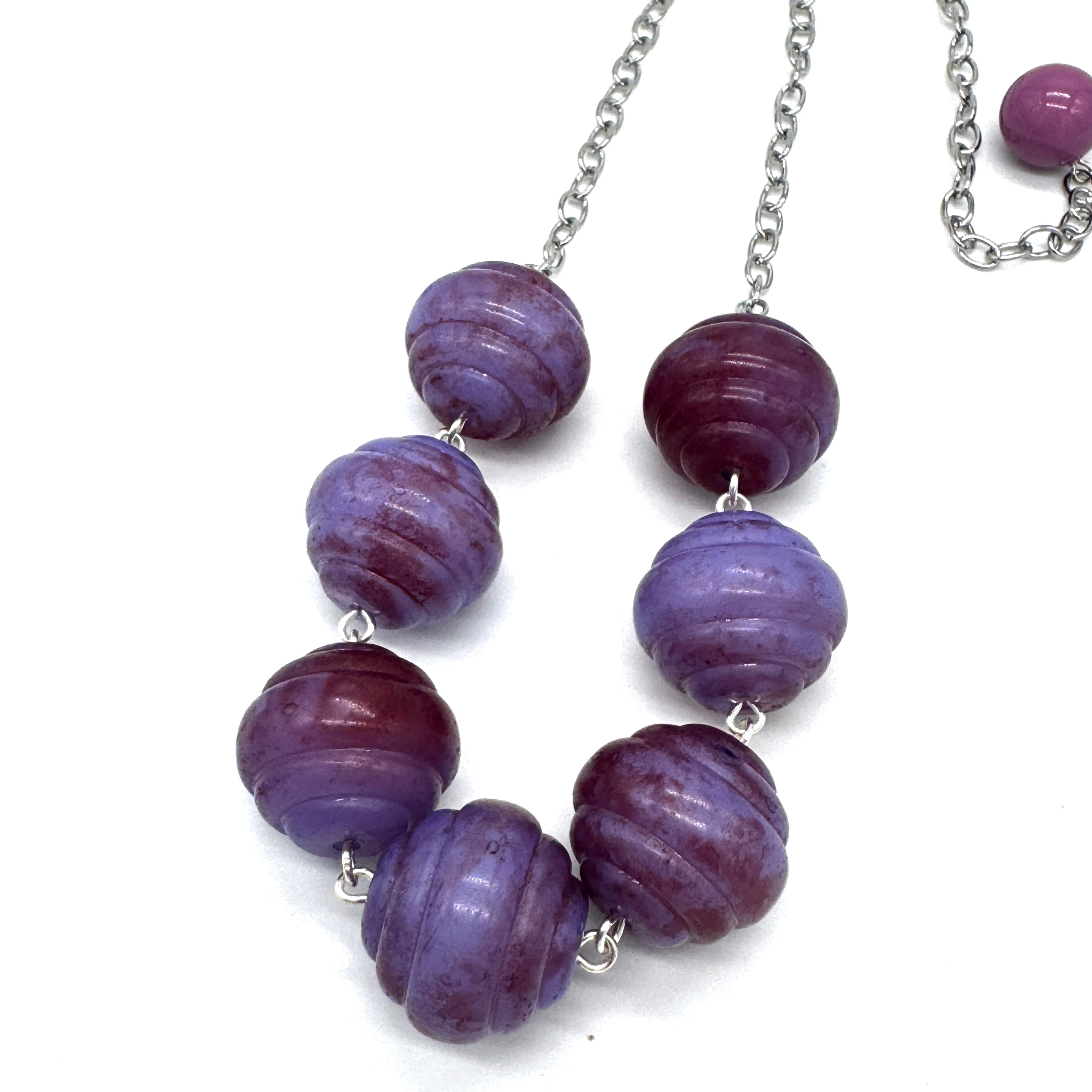 Necklace with purple beads on a white background