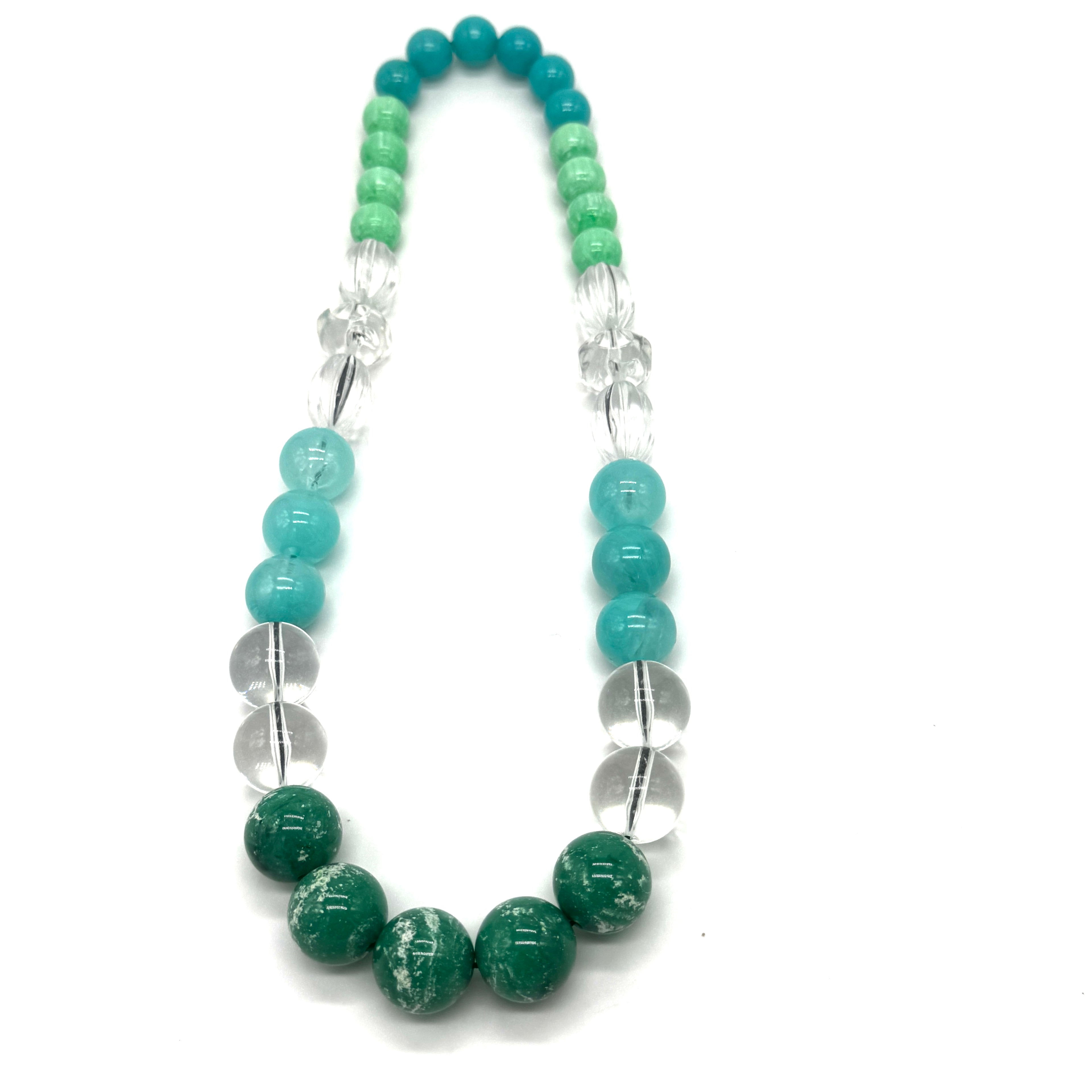 Necklace with green, blue, and clear beads on a white background
