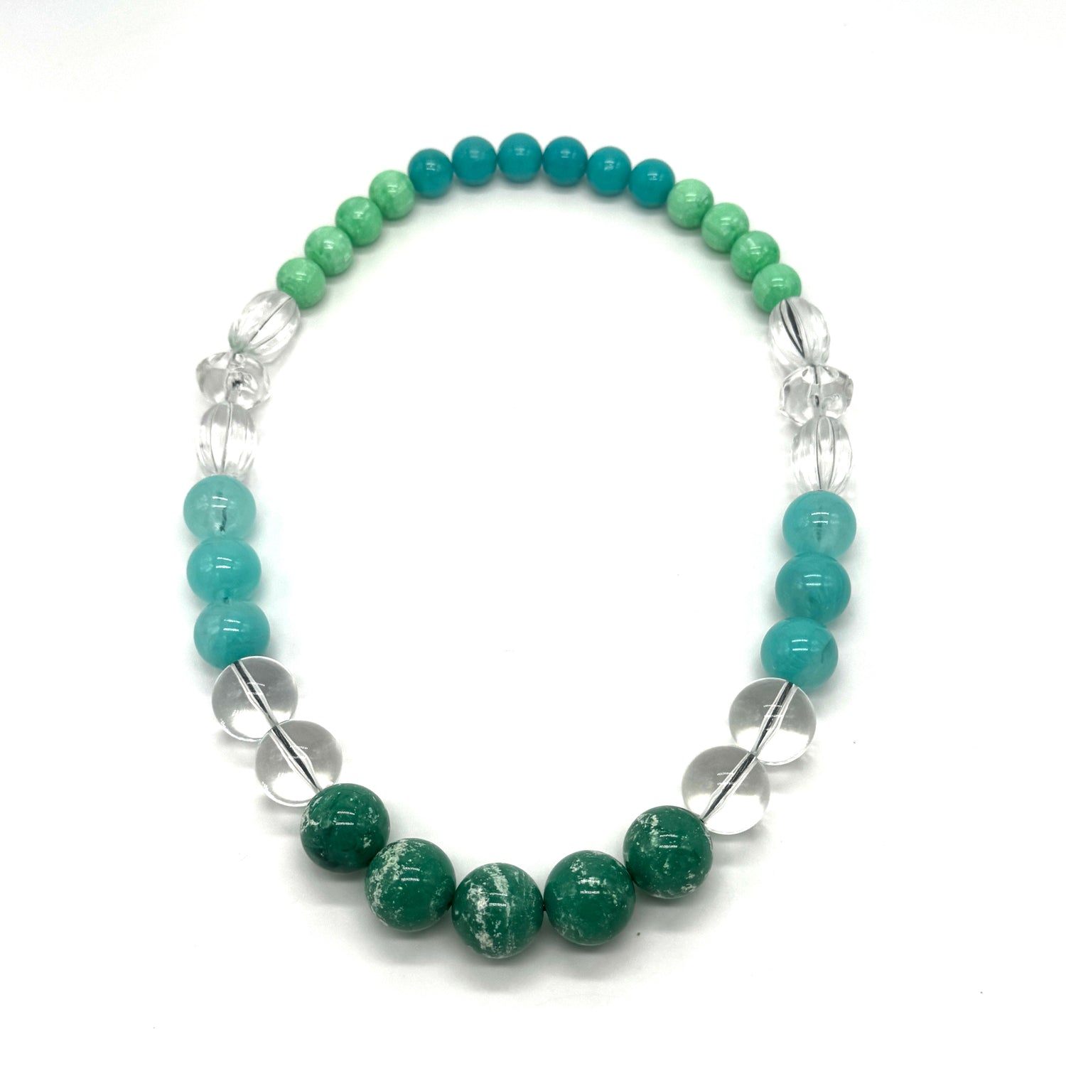 Necklace with green and blue beads on a white background