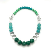 Necklace with green and blue beads on a white background