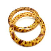 Two tortoiseshell bangles stacked on a white background