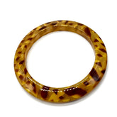 Tortoiseshell bangle on a white background