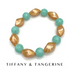 Bracelet with gold and turquoise beads on a white background, featuring &