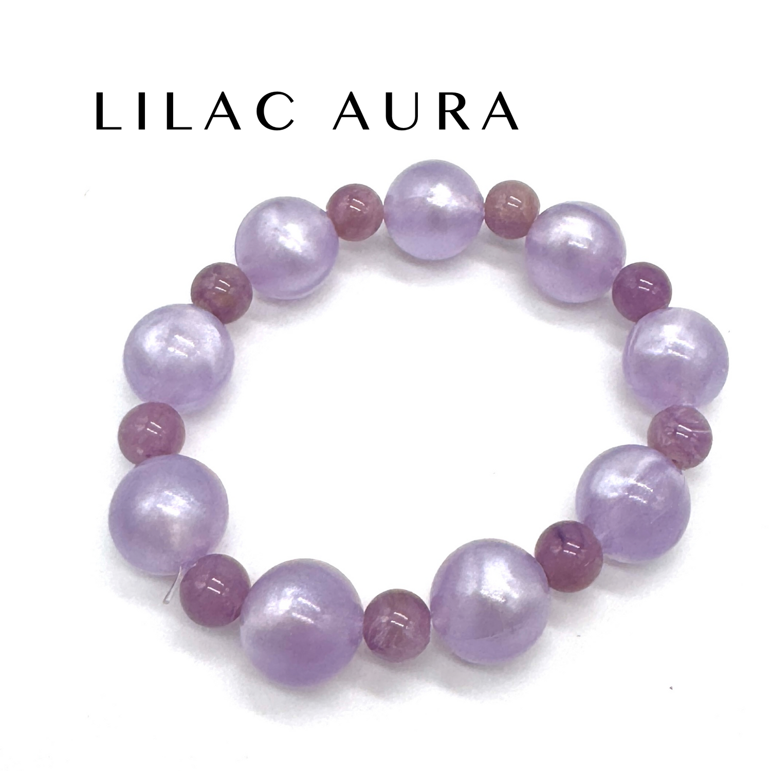 Lilac and pink beaded bracelet on a white background with &