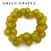 Green beaded bracelet  on a white background with &