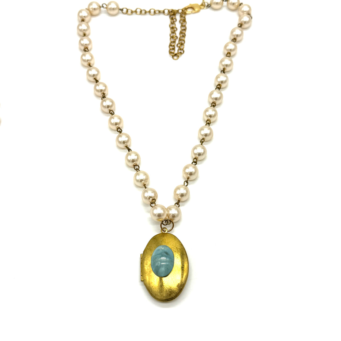 Pearl necklace with a gold locket on a white background