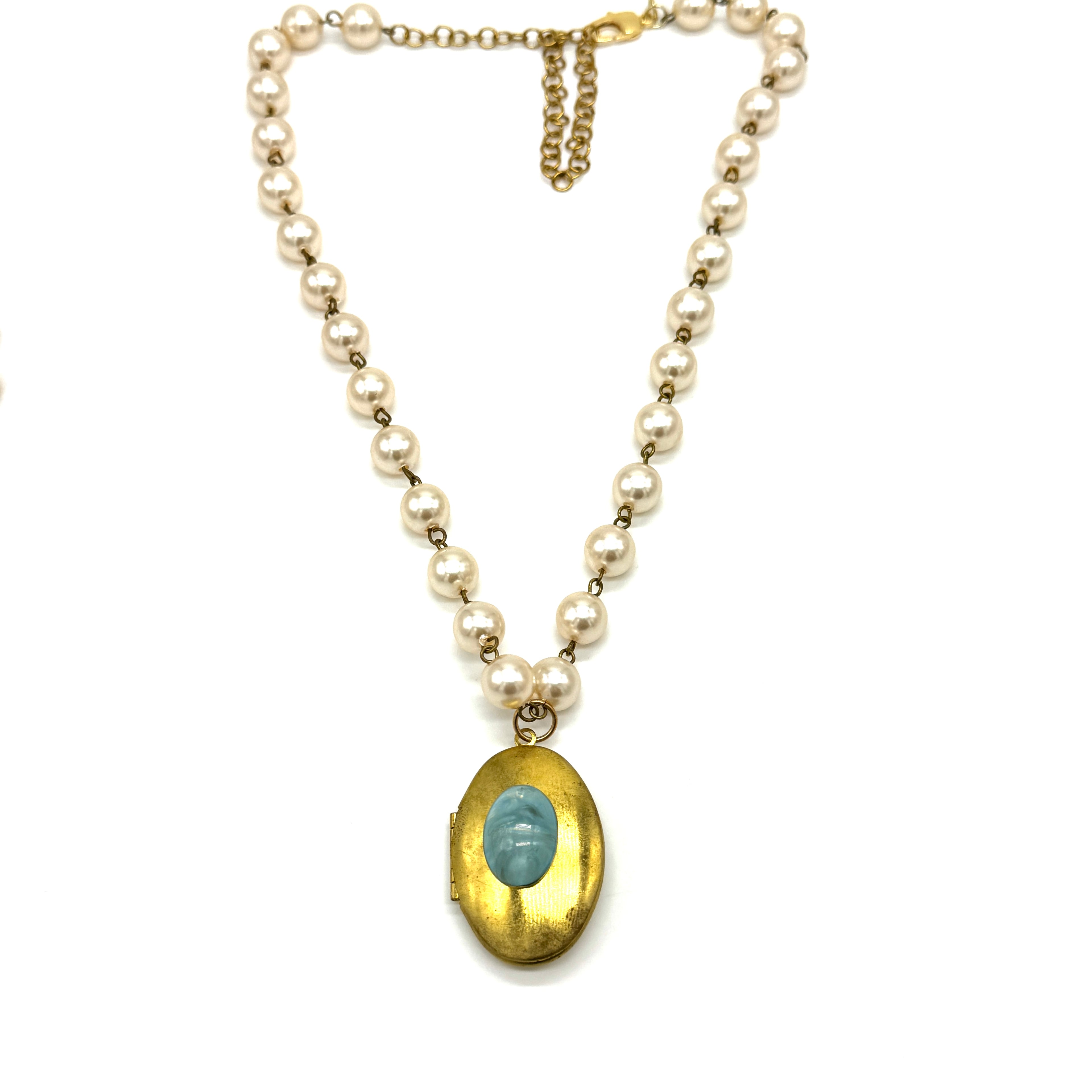 Pearl necklace with a gold locket on a white background