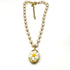 Pearl necklace with a daisy flower pendant on a white background