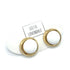 Gold and white stud earrings on a white card with &