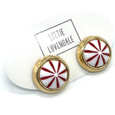 Pair of earrings with red and white design on a white background