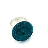 Teal lucite ring with silver band on a white background