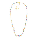 A golden chain necklace with colorful enameled links on a white background.