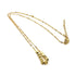 A gold necklace on a white background. It is a fine chain with several cube beads at the center.