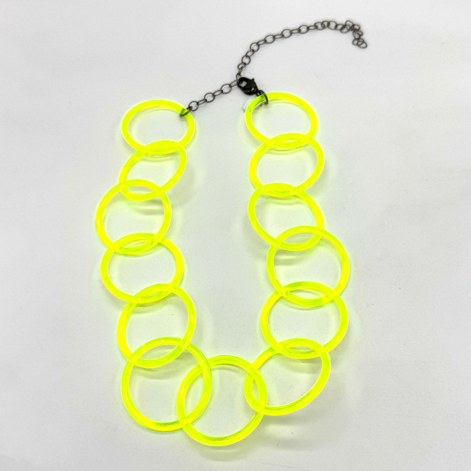 Adjustable necklace featuring large lucite chain links in a neon yellow