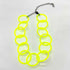 Adjustable necklace featuring large lucite chain links in a neon yellow