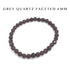 Gray quartz faceted 6mm bead bracelet on a white background