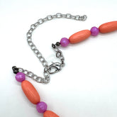 Close up of bright coral and pink beaded necklace&