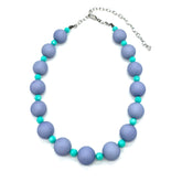 Adjustable necklace featuring chunky periwinkle lucite beads and smaller faceted turquoise spacers on a white background.