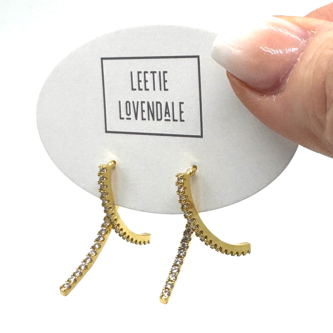 Golden stud earrings with an intersecting silhouette accented with sparkling cubic zirconias.