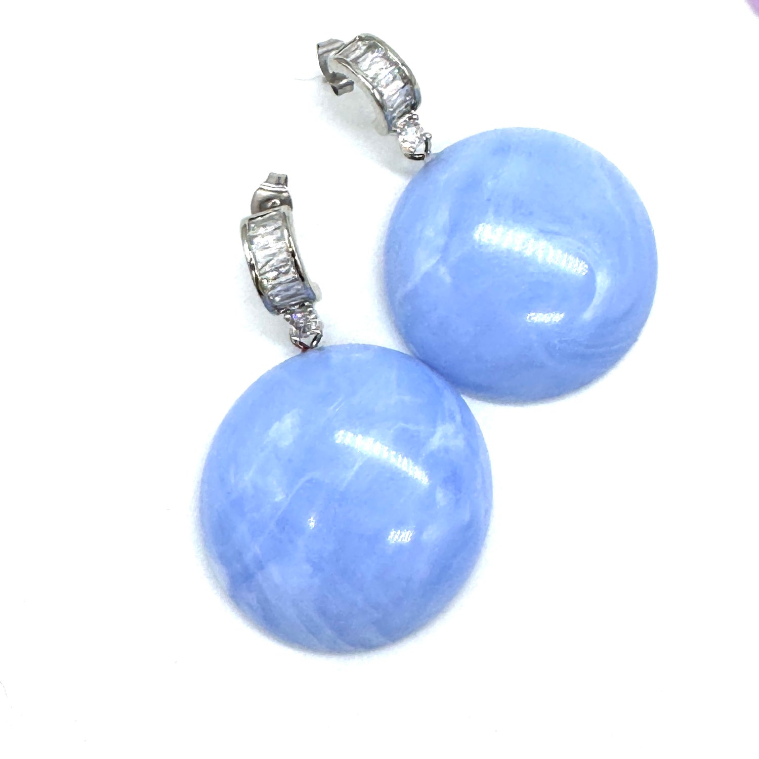 Periwinkle swirled lucite drops dangle from crystal-embellished earwires.
