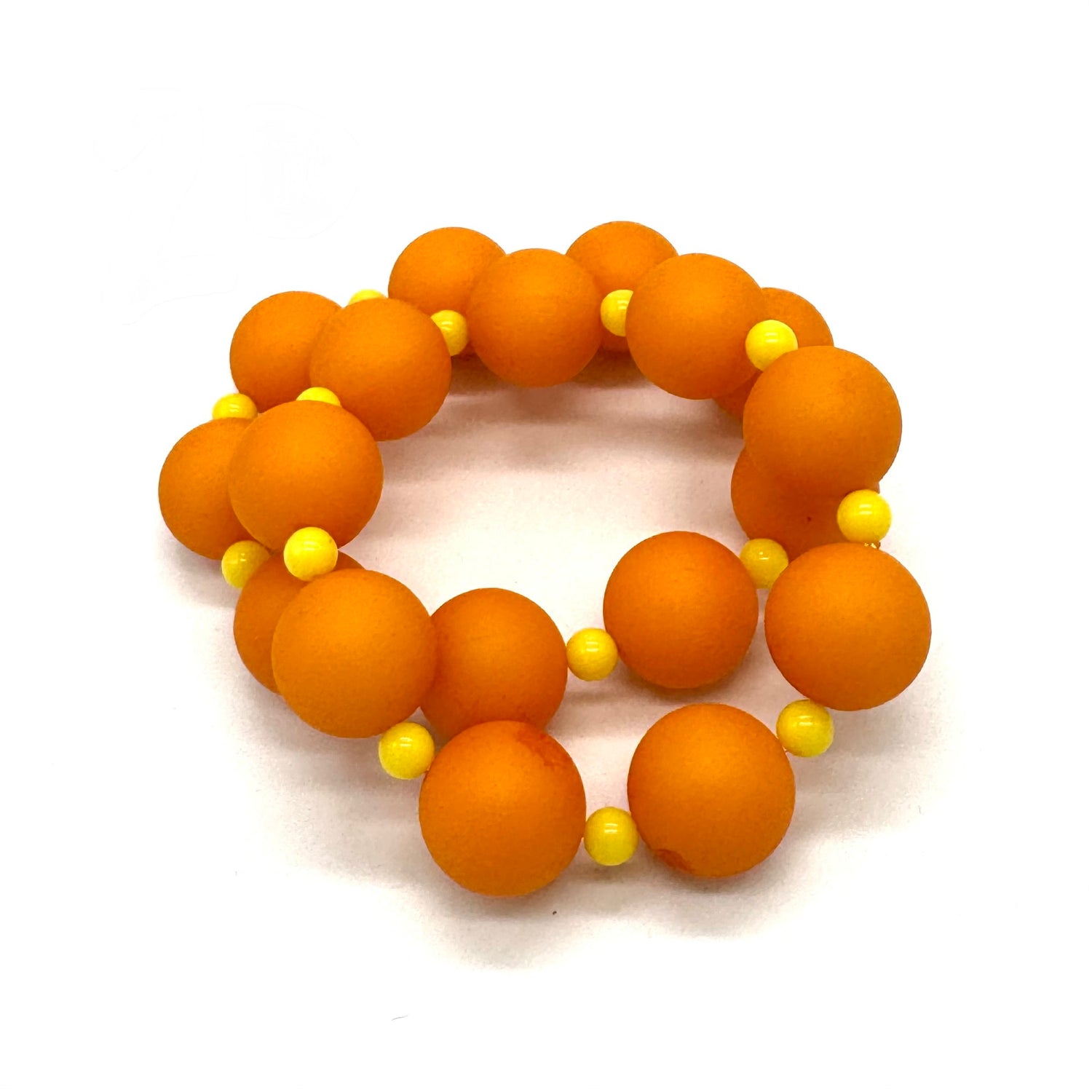 Two orange beaded bracelets with yellow accents on a white background