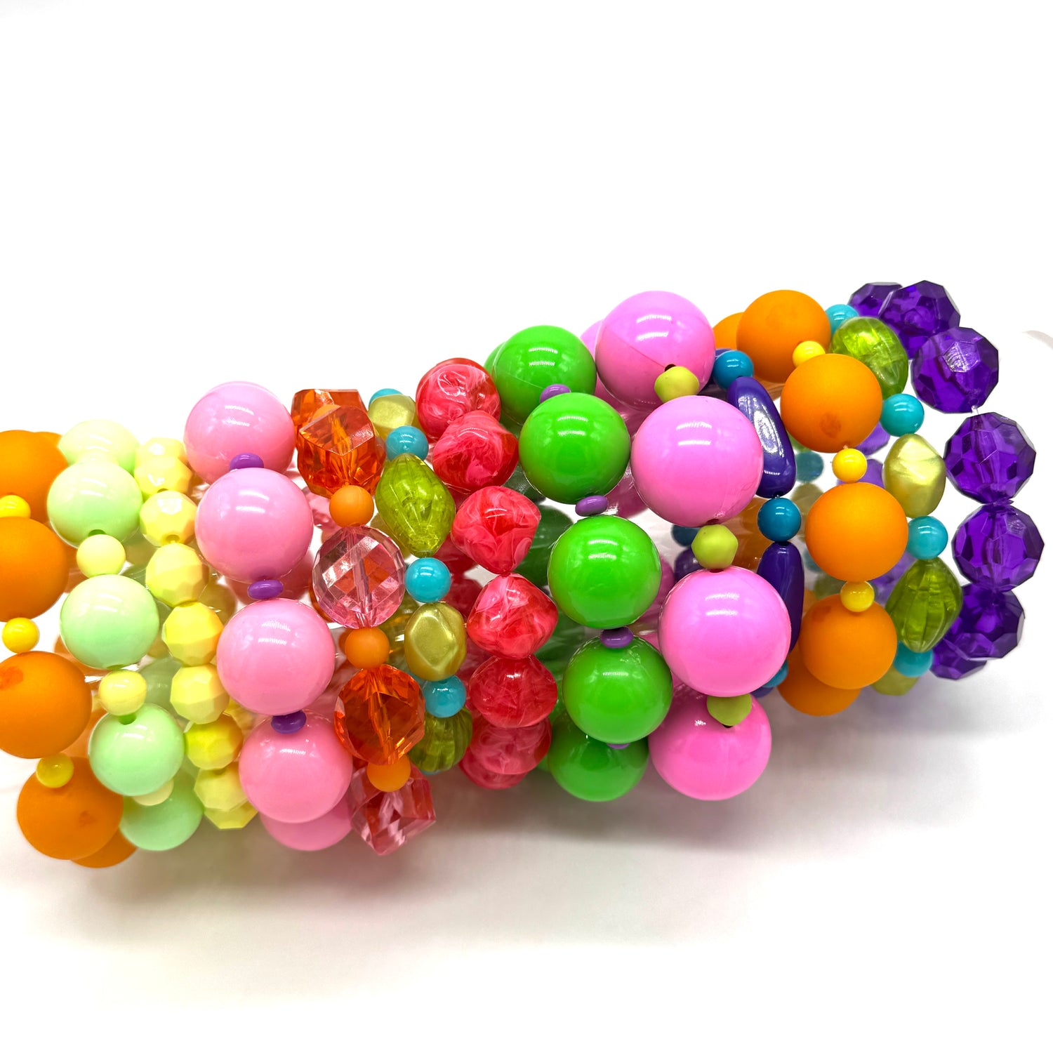 Colorful beaded bracelets with various shapes and sizes on a white background